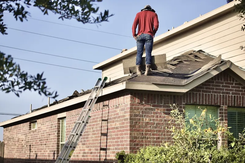 Professional roofer working on a residential roof in Friendship Woods